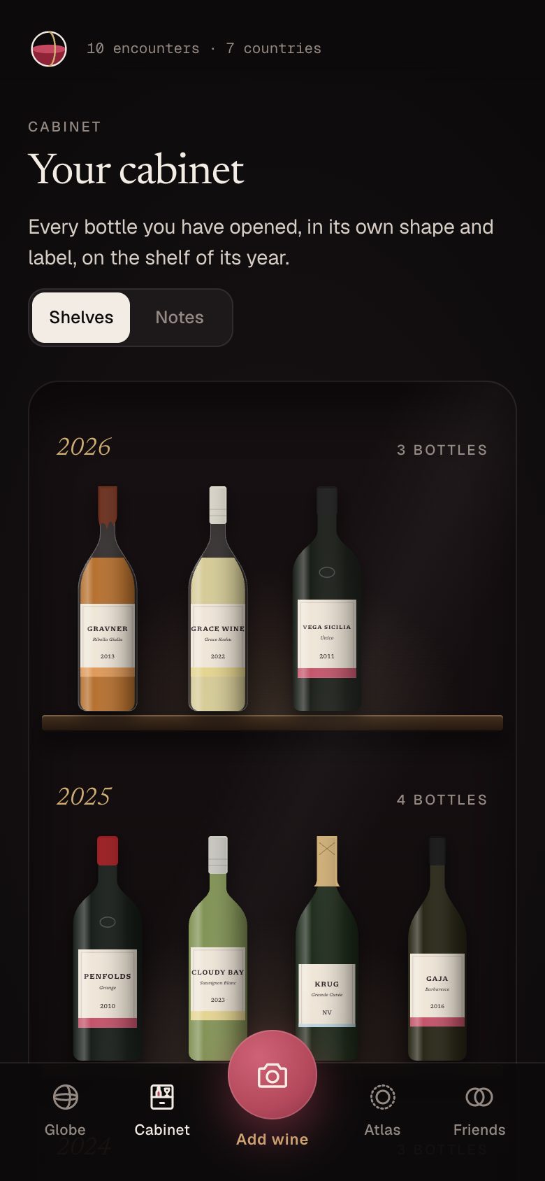 A dark wooden cabinet with bottles from Gravner, Grace Wine, Vega Sicilia, Penfolds, Cloudy Bay, Krug and Gaja on shelves by year.