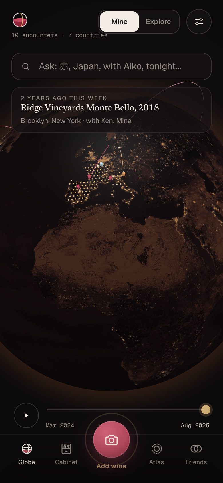 The VinoEarth globe at night, with gold dots over tasted countries and pins for each wine.